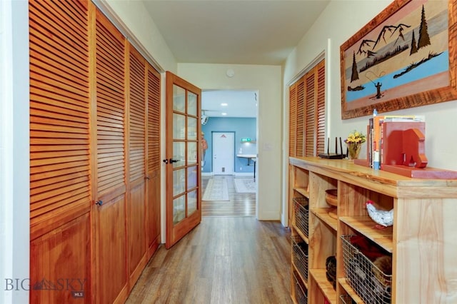 hallway featuring light wood-style floors, french doors, and recessed lighting