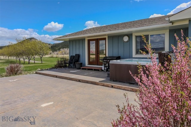 exterior space featuring a hot tub, french doors, and grilling area