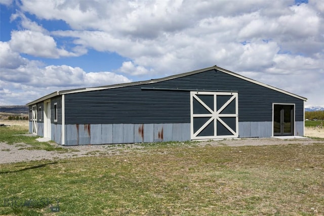 view of pole building with a yard