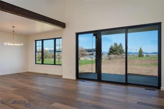5680 Staffanson Rd, Bozeman, MT 59718 - doorway featuring dark wood-type flooring, baseboards, beamed ceiling, and a mountain view