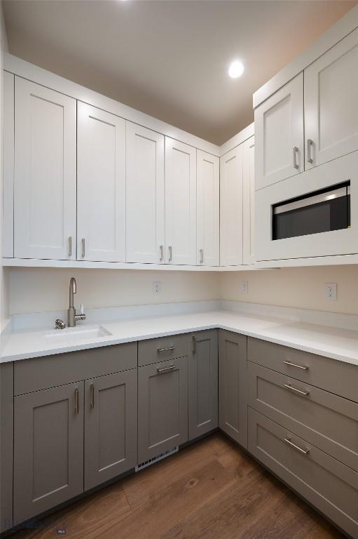 5680 Staffanson Rd, Bozeman, MT 59718 - kitchen with gray cabinets, a sink, dark wood finished floors, light countertops, and recessed lighting