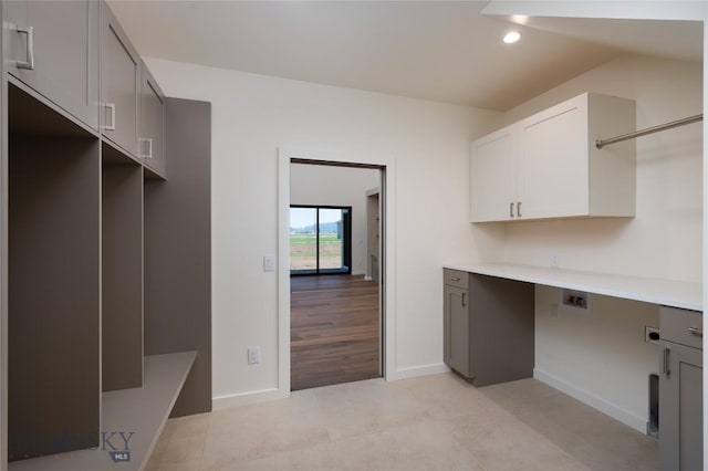 5680 Staffanson Rd, Bozeman, MT 59718 - washroom featuring cabinet space, baseboards, recessed lighting, light tile patterned floors, and hookup for a washing machine