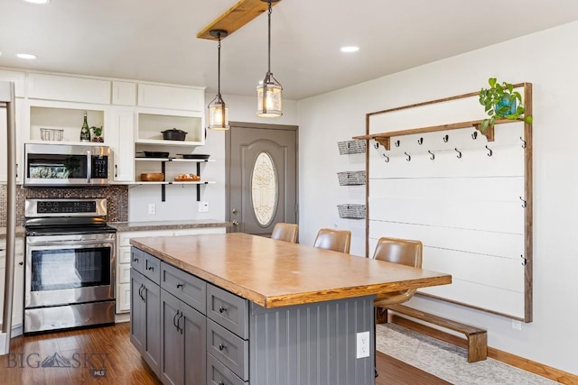 kitchen featuring open shelves, gray cabinetry, stainless steel appliances, and dark wood-style flooring