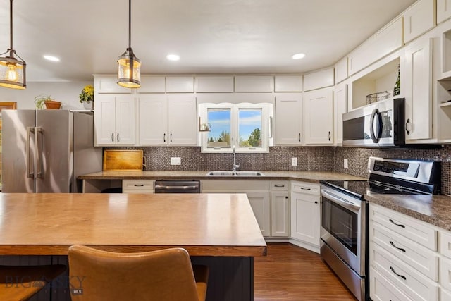 kitchen with a sink, open shelves, stainless steel appliances, white cabinetry, and dark wood-style flooring