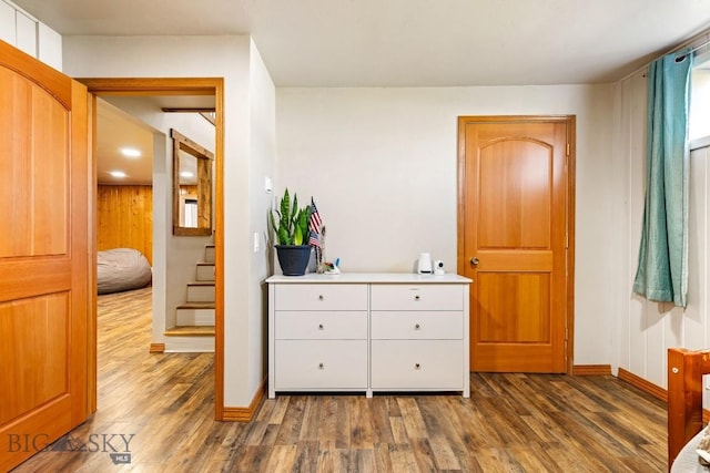 bedroom featuring baseboards and dark wood finished floors