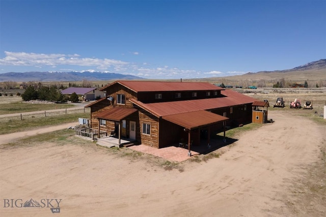 2 Dayspring Rd W, Sheridan, MT 59749 - view of front of home featuring a mountain view, stone siding, and metal roof