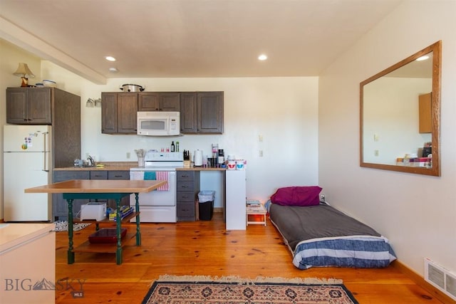 2 Dayspring Rd W, Sheridan, MT 59749 - kitchen with white appliances, dark brown cabinetry, light wood-type flooring, recessed lighting, and light countertops