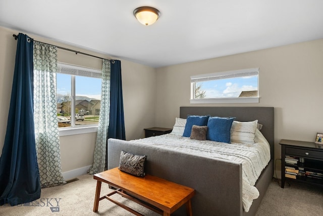 bedroom with carpet floors and baseboards