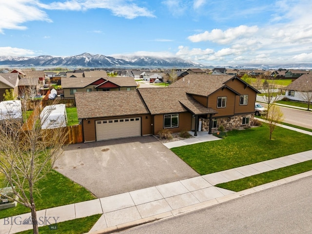 view of front of house with a residential view, asphalt driveway, stone siding, and a mountain view