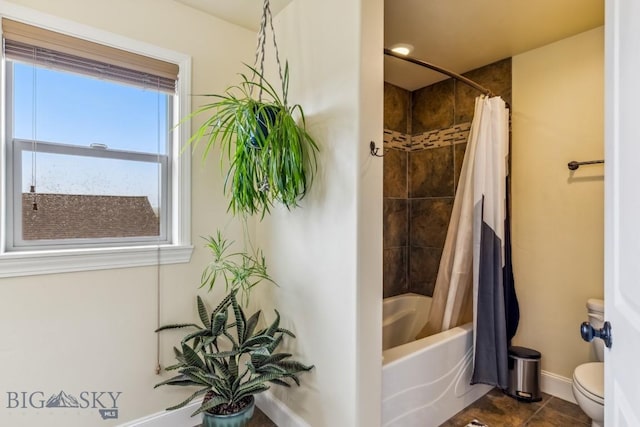 304 Farmall Ln, Manhattan, MT 59741 - full bathroom with toilet, baseboards, shower / bath combo with shower curtain, and tile patterned floors