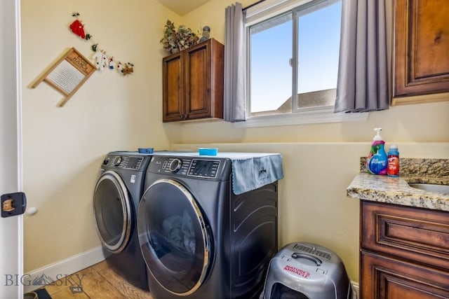 304 Farmall Ln, Manhattan, MT 59741 - clothes washing area featuring washing machine and clothes dryer, cabinet space, and baseboards
