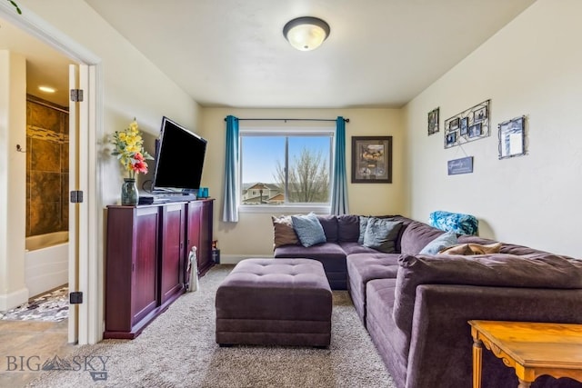 carpeted living room featuring baseboards