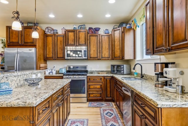 304 Farmall Ln, Manhattan, MT 59741 - kitchen with stainless steel appliances, a sink, light wood finished floors, light stone counters, and recessed lighting