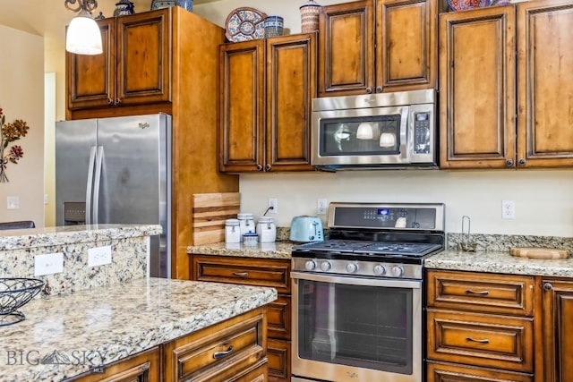 304 Farmall Ln, Manhattan, MT 59741 - kitchen with appliances with stainless steel finishes, brown cabinets, and light stone counters
