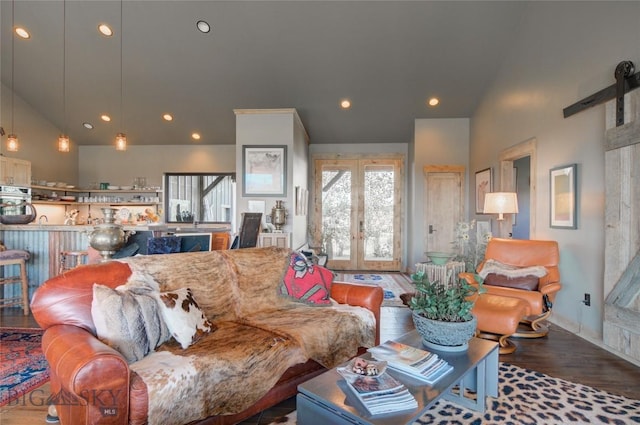 11762 Gooch Hill Rd, Gallatin Gateway, MT 59730 - living area with high vaulted ceiling, wood finished floors, a barn door, french doors, and recessed lighting