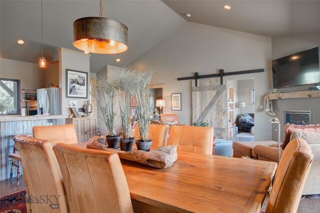 11762 Gooch Hill Rd, Gallatin Gateway, MT 59730 - dining space with a barn door, recessed lighting, and high vaulted ceiling