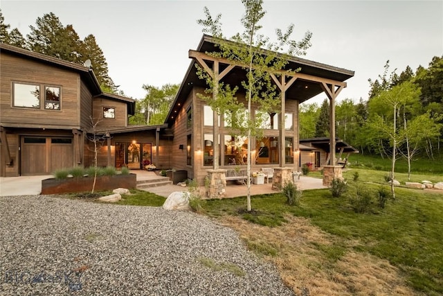 back of property featuring driveway and an attached garage