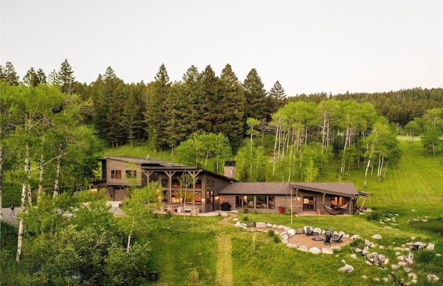 view of subject property featuring a forest