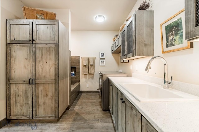 laundry room featuring cabinet space, independent washer and dryer, wood finished floors, and baseboards