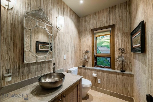 bathroom with toilet, tile patterned floors, and vanity