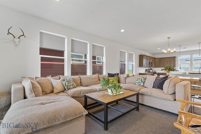 living area with a chandelier, recessed lighting, and carpet flooring
