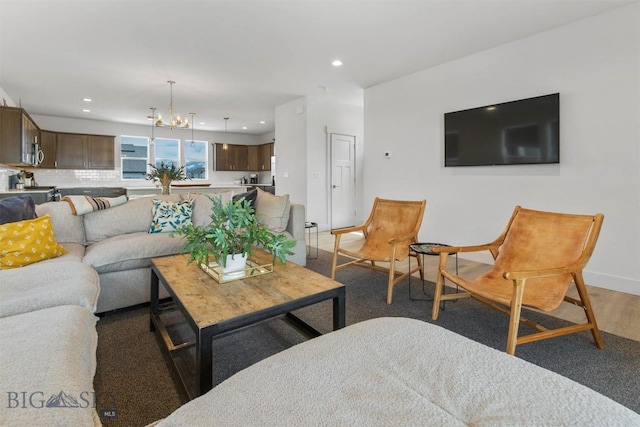 living room with a chandelier, recessed lighting, and baseboards