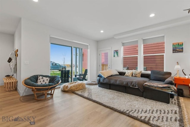 living room featuring wood finished floors, recessed lighting, and baseboards