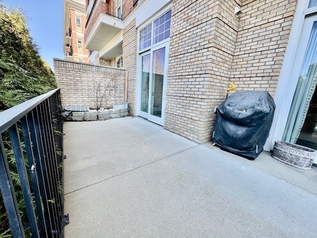 view of patio featuring a balcony and grilling area