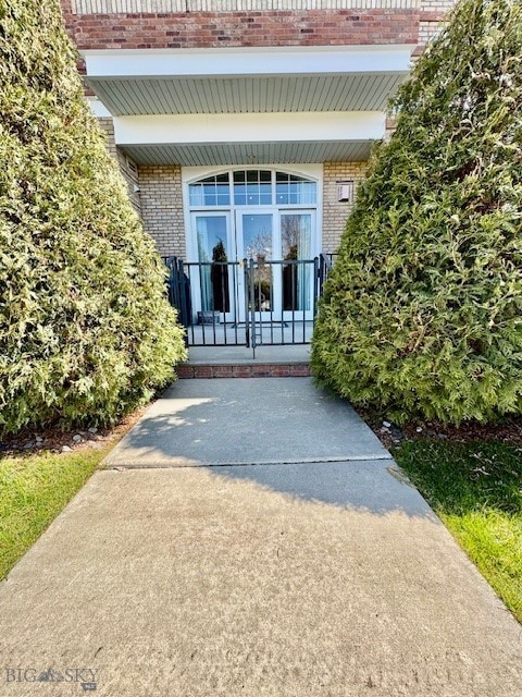 property entrance with brick siding and covered porch