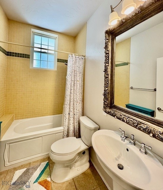 bathroom with a sink, toilet, shower / tub combo, and tile patterned floors