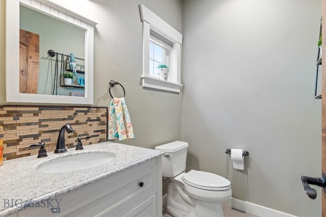 754 Milestone Dr, Belgrade, MT 59714 - bathroom featuring decorative backsplash, toilet, vanity, and baseboards