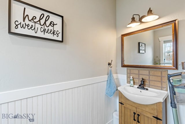 754 Milestone Dr, Belgrade, MT 59714 - bathroom with wainscoting, vanity, and toilet