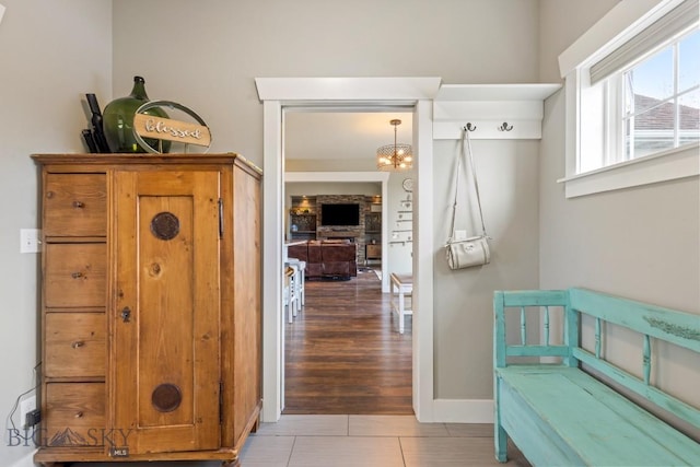 754 Milestone Dr, Belgrade, MT 59714 - corridor featuring tile patterned flooring, baseboards, and a chandelier