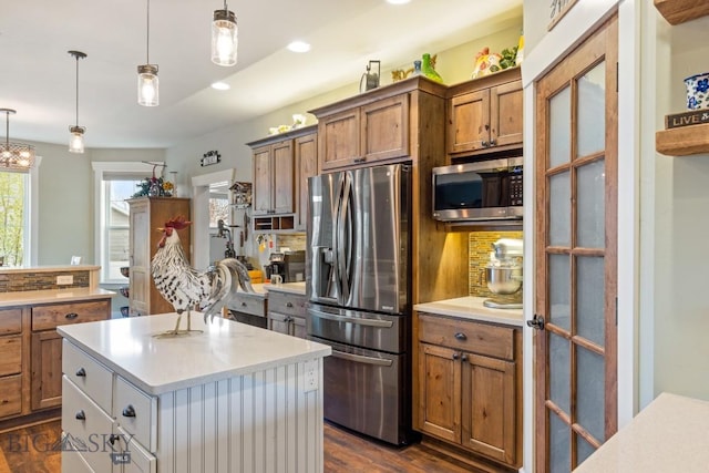 754 Milestone Dr, Belgrade, MT 59714 - kitchen with stainless steel appliances, brown cabinetry, dark wood-style flooring, light countertops, and recessed lighting