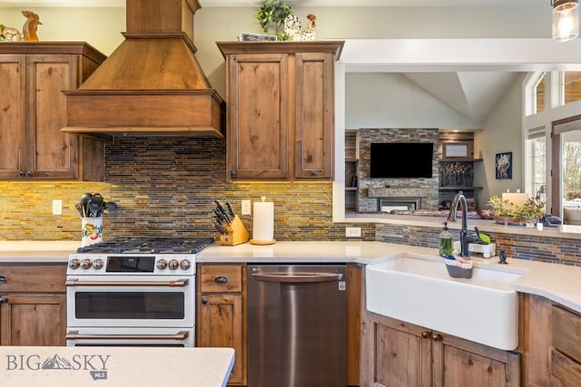 754 Milestone Dr, Belgrade, MT 59714 - kitchen with dishwasher, range with gas cooktop, a sink, premium range hood, and tasteful backsplash
