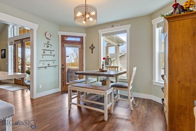754 Milestone Dr, Belgrade, MT 59714 - dining space featuring healthy amount of natural light, a chandelier, baseboards, and dark wood-style flooring