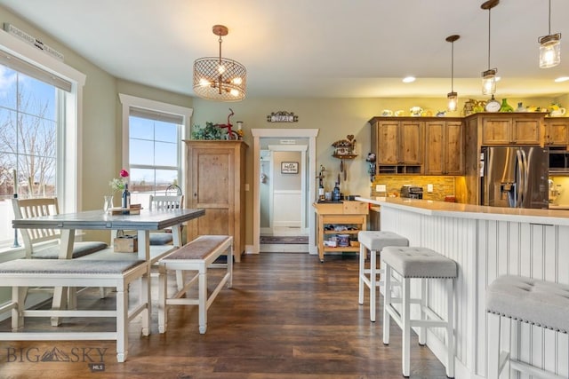 754 Milestone Dr, Belgrade, MT 59714 - dining room featuring dark wood finished floors and a chandelier
