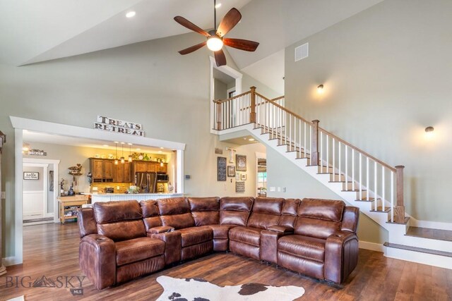 754 Milestone Dr, Belgrade, MT 59714 - living area with high vaulted ceiling, dark wood finished floors, stairs, and ceiling fan