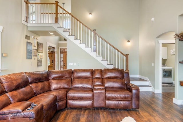 754 Milestone Dr, Belgrade, MT 59714 - living area featuring washer / clothes dryer, a high ceiling, wood finished floors, arched walkways, and baseboards
