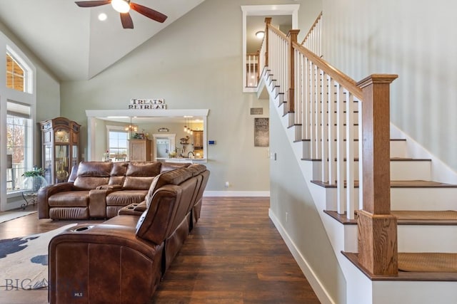 754 Milestone Dr, Belgrade, MT 59714 - living room featuring high vaulted ceiling, dark wood-style floors, a ceiling fan, baseboards, and stairs