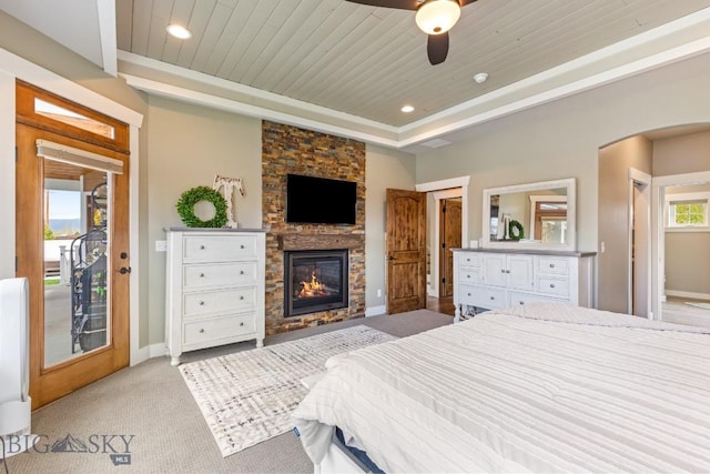 754 Milestone Dr, Belgrade, MT 59714 - bedroom featuring a fireplace, access to exterior, light carpet, baseboards, and wooden ceiling