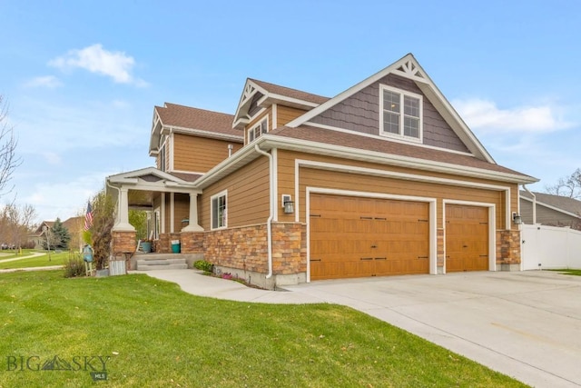 754 Milestone Dr, Belgrade, MT 59714 - view of front facade featuring stone siding, concrete driveway, a garage, and covered porch