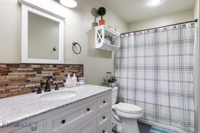 754 Milestone Dr, Belgrade, MT 59714 - bathroom featuring tasteful backsplash, toilet, vanity, and a shower with shower curtain