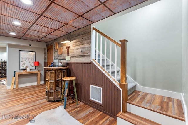 754 Milestone Dr, Belgrade, MT 59714 - indoor dry bar featuring wood walls, stairway, wood finished floors, baseboards, and recessed lighting