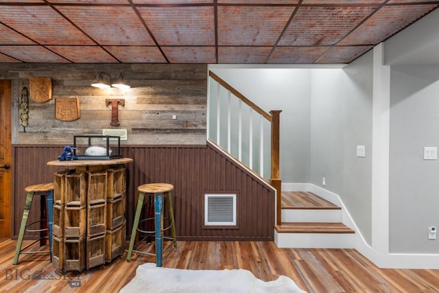 754 Milestone Dr, Belgrade, MT 59714 - bar featuring wood walls, stairway, wood finished floors, and baseboards
