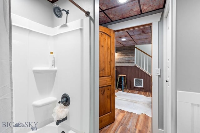 754 Milestone Dr, Belgrade, MT 59714 - full bath featuring wood walls, wood finished floors, and tub / shower combination