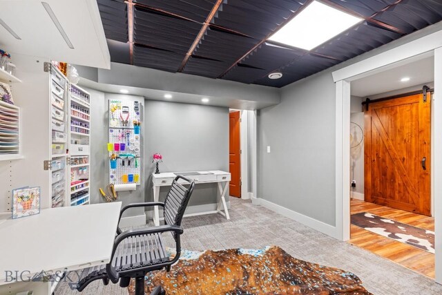754 Milestone Dr, Belgrade, MT 59714 - carpeted office featuring baseboards, a barn door, and recessed lighting