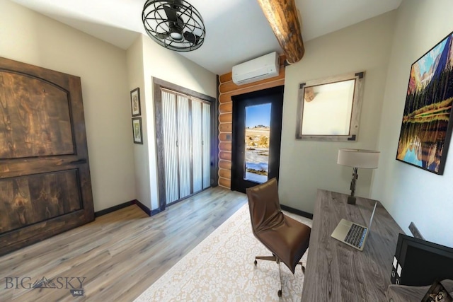 home office with a wall mounted AC, wood finished floors, beam ceiling, and baseboards