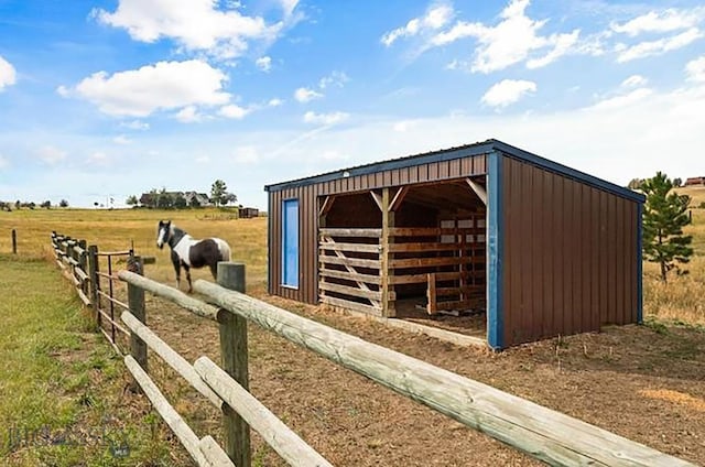 view of outdoor structure featuring an outbuilding and a view of rural / pastoral area