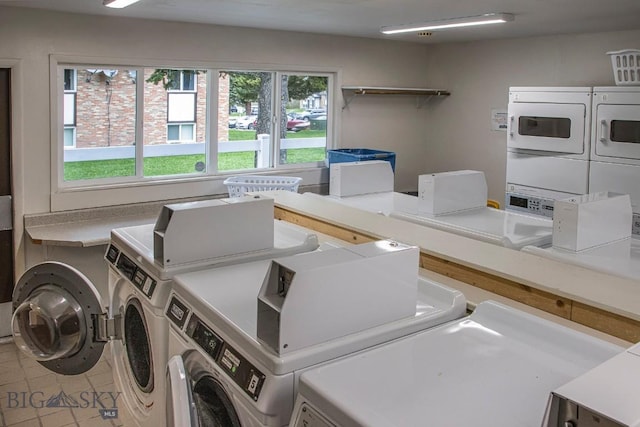 communal laundry room featuring stacked washer / dryer, independent washer and dryer, and tile patterned floors